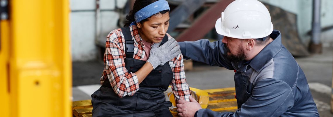Women with shoulder injury at warehouse