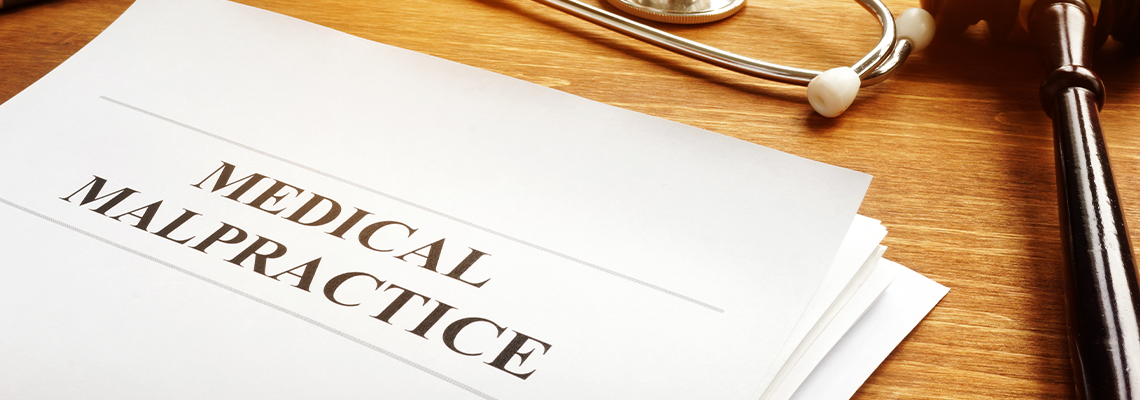 Medical malpractice report and stethoscope