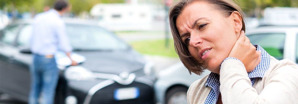 Woman feeling pain after car accident in the city