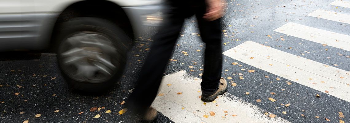 Car about to collide with pedestrian in crosswalk
