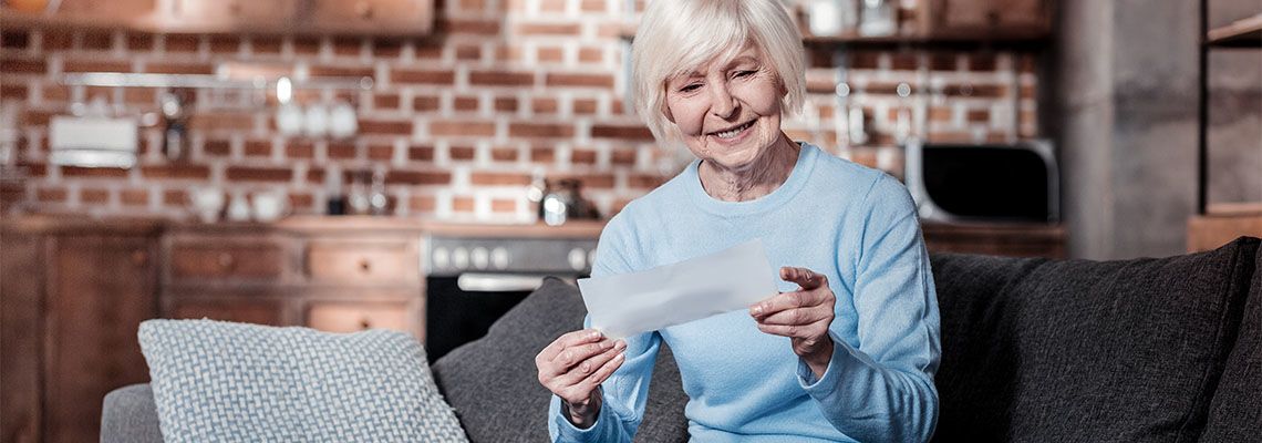 Senior woman smiling while reviewing documents