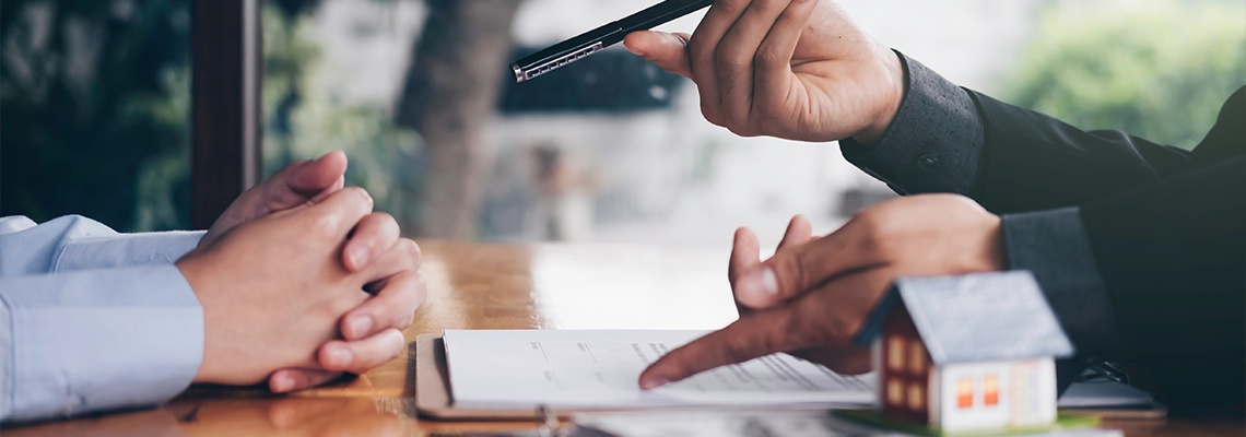 Real Estate Agent Holding House Key to His Client After Signing Contrac