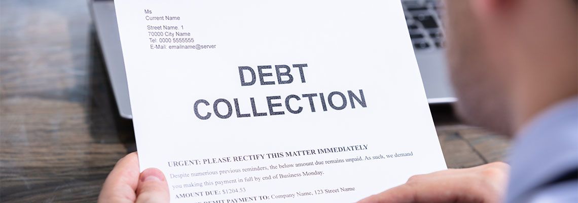 Man Reading Debt Collection Letter