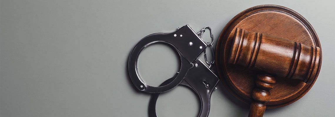 Gavel and Handcuff in table