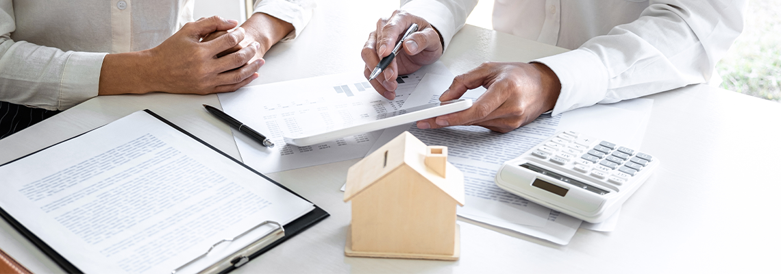 Two people at desk going over paperwork