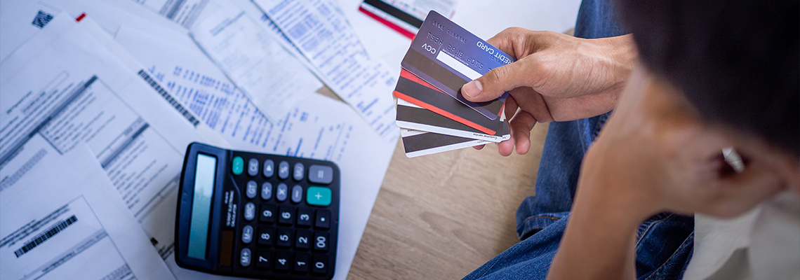 Person Stressed About Credit Card Debt and Many Bills on The Floor