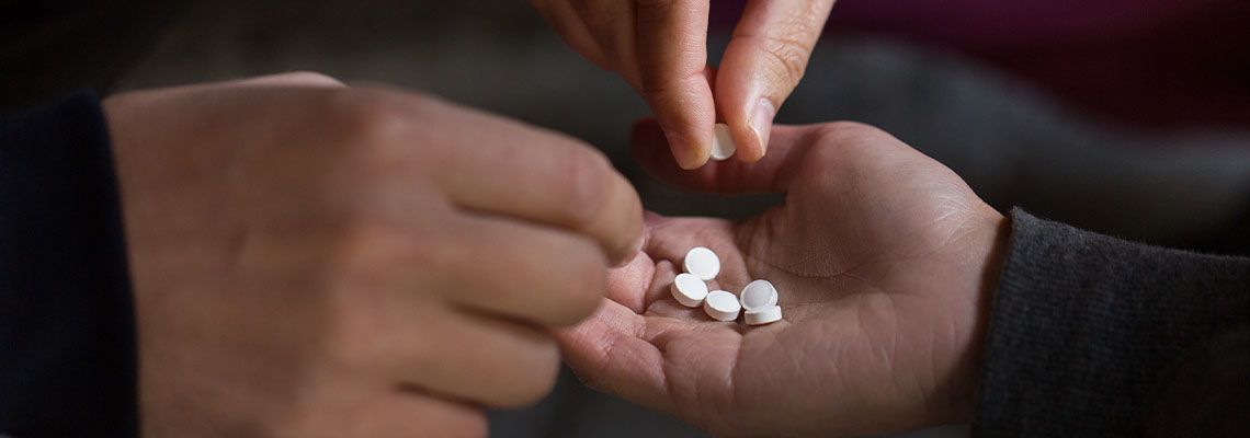 Close up of addicts using drug pills