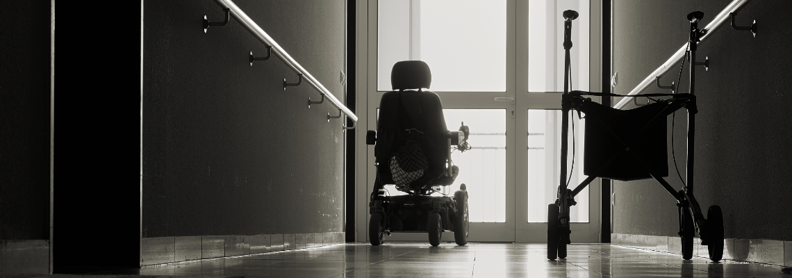 Wheelchair and walking in empty nursing home hall