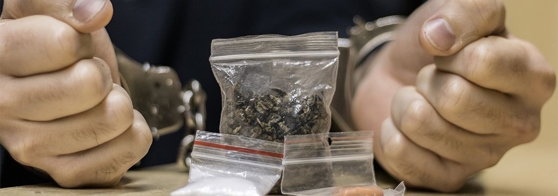 Handcuffed man for possession of drugs