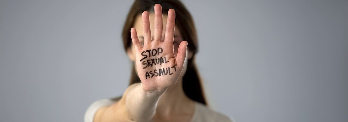 Stop sexual assault sign on womans hand