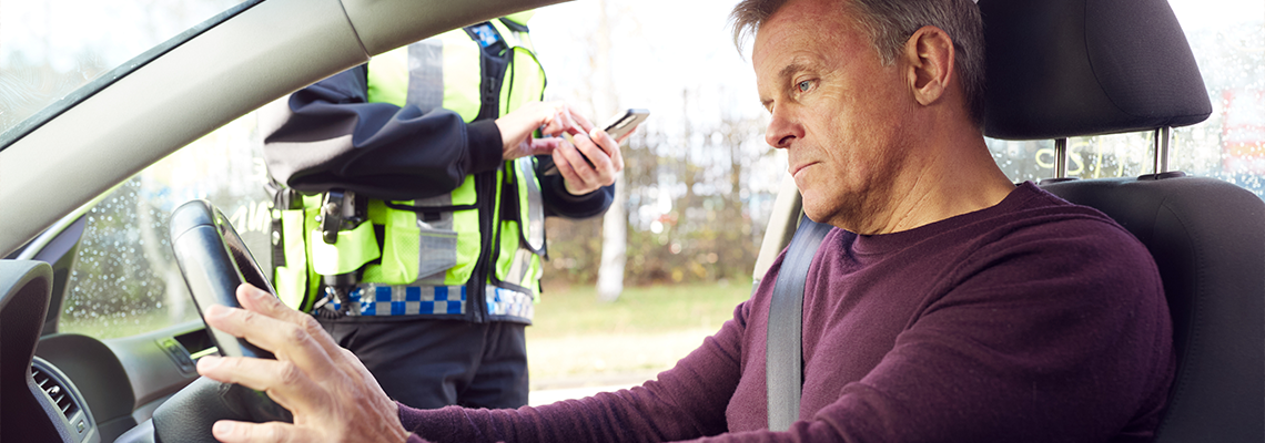 Male Driver Being Stopped By Female Traffic Police Officer With Digital Tablet