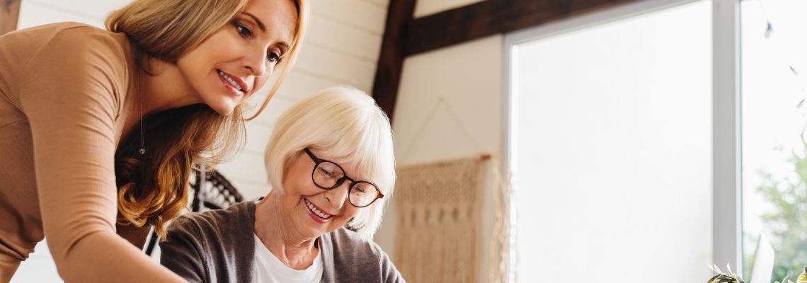 Senior women preparing last will document with help of a young women