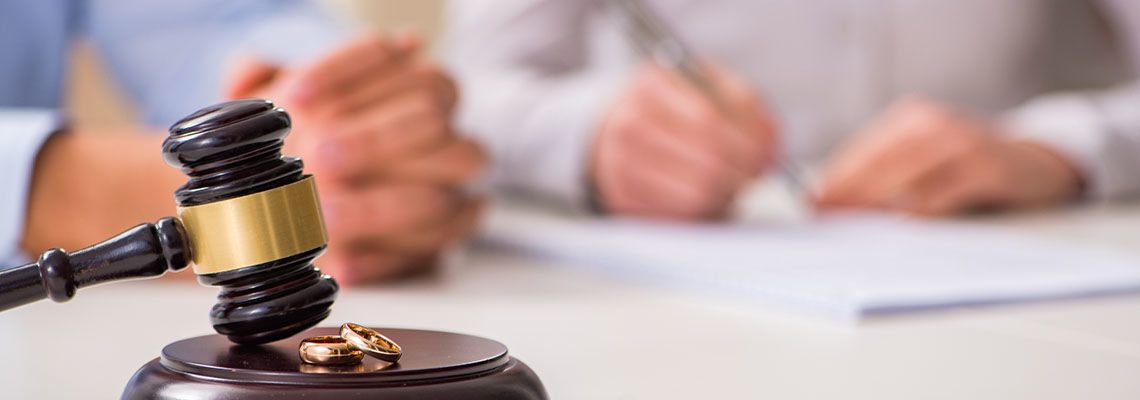 Wedding Rings, Judge Gavel and Couples Signing Divorce Papers