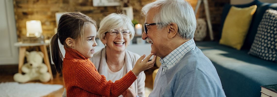 Cute small girl spending time with her grandparents