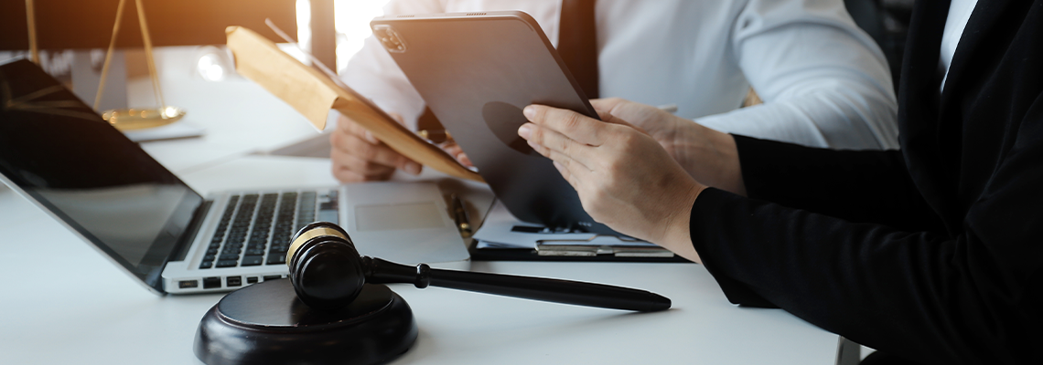 Male lawyer working with contract papers and wooden gavel on tabel