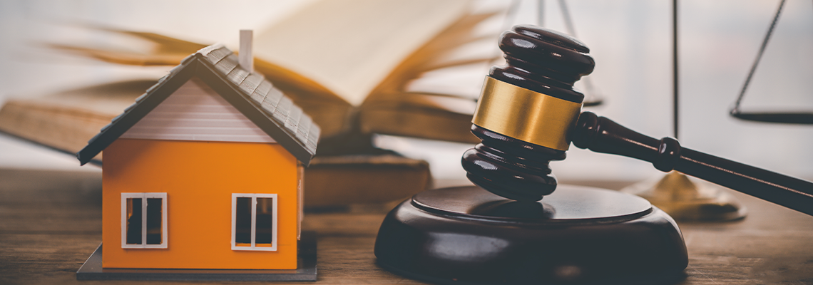 Model of house and gavel.House auction real estate law concept