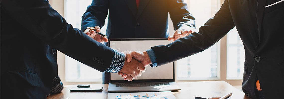 Businessmen shaking hands over a table