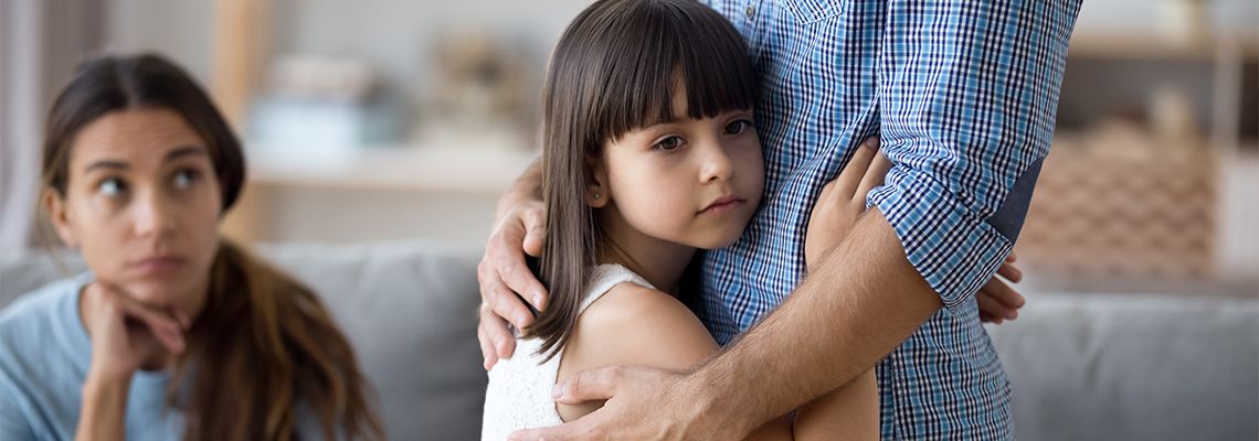 Sad child hugging dad who is moving out