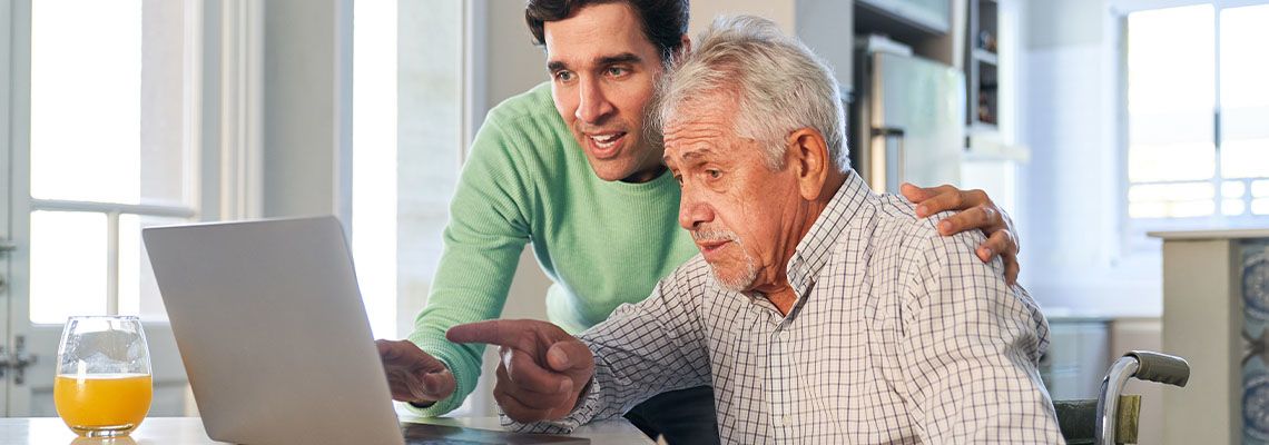 Senior man in wheelchair with his guardian