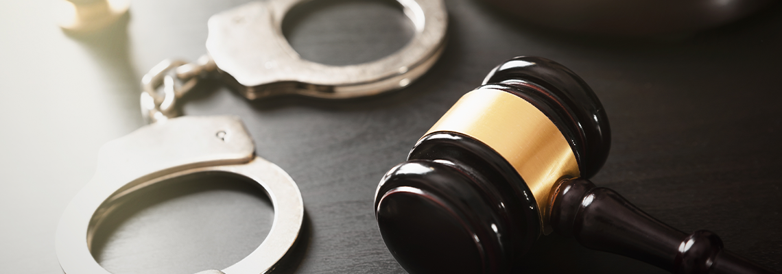Gavel and handcuff on table