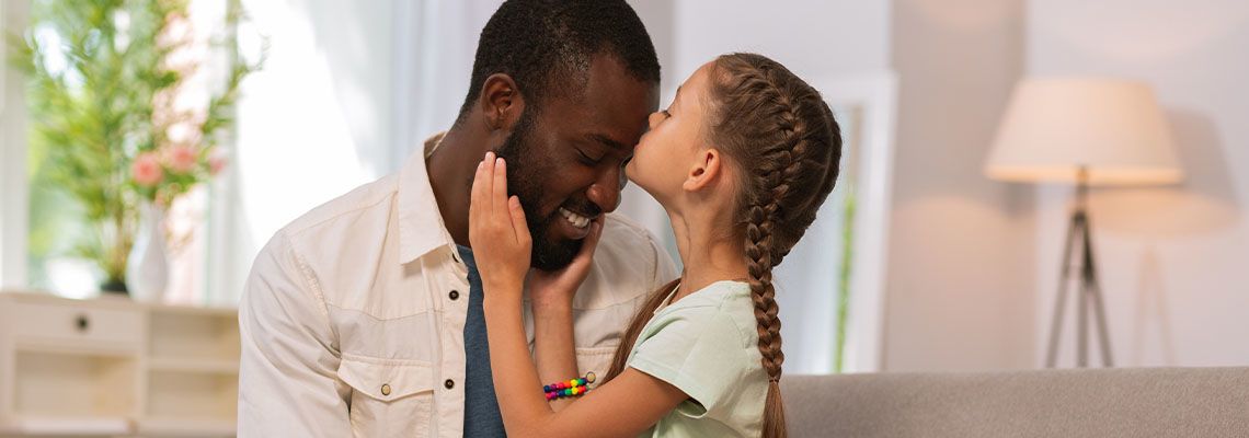 Pretty girl kissing her father