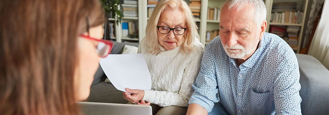 Old couples review and sign power of attorney document