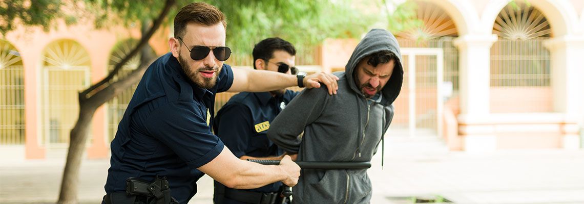 Two police officer arresting a man