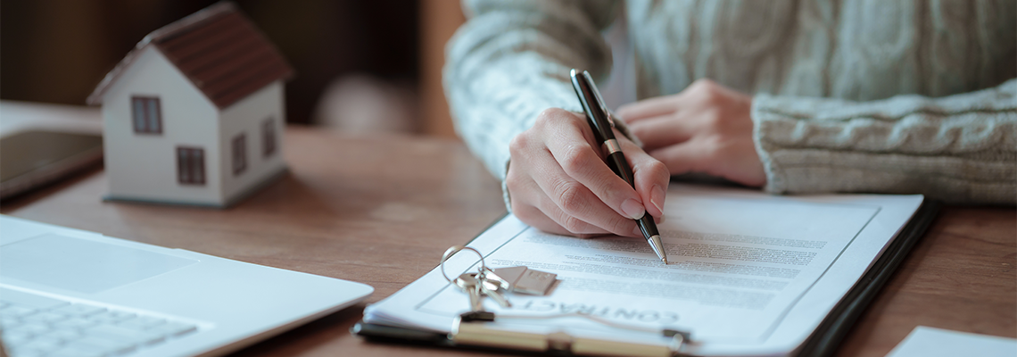A real estate professional reviews and signs a property agreement