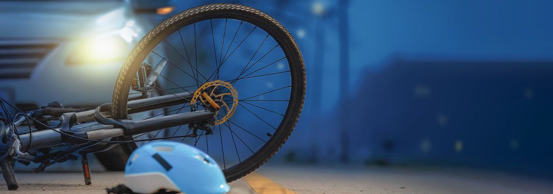 Bicycle lying on side in road in front of car