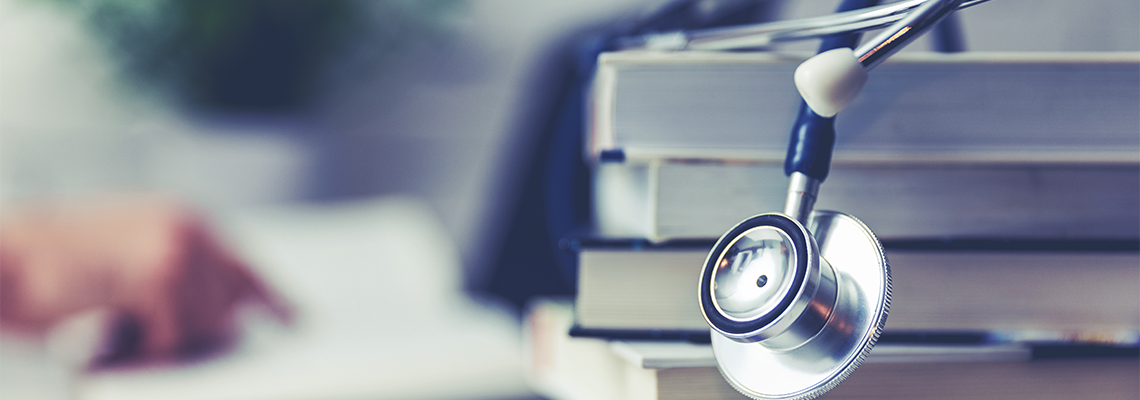Stethoscope on top of a stack of books