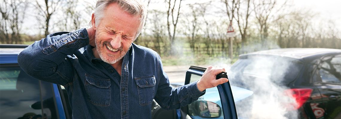 Driver With Whiplash Injury Getting Out Of Car After Accident