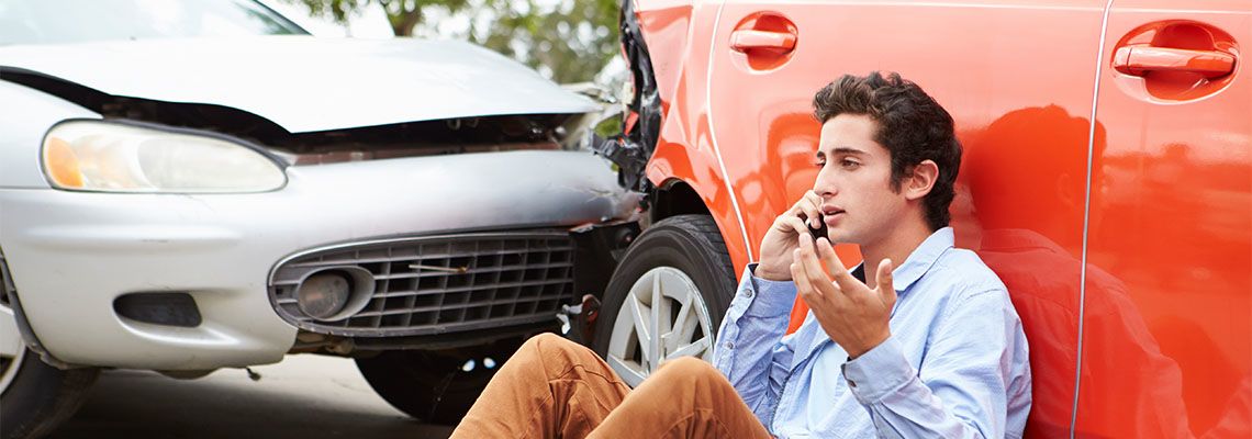 Teenage Driver Making Phone Call After Traffic Accident
