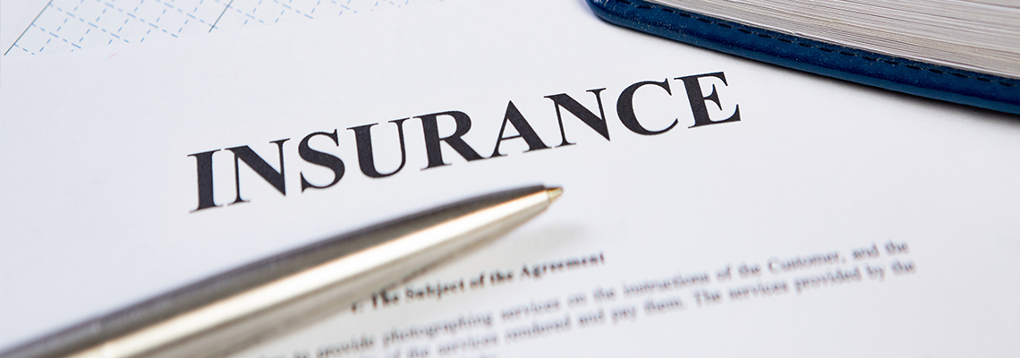 Modern Pen on Insurance Contract with Planning in Background.