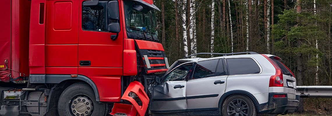 Collision between car and truck in highway