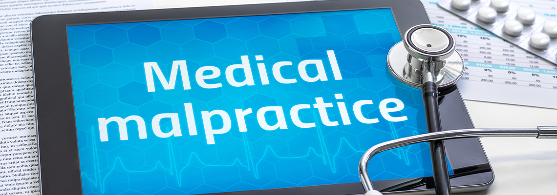 The word Medical malpractice on the display of a tablet