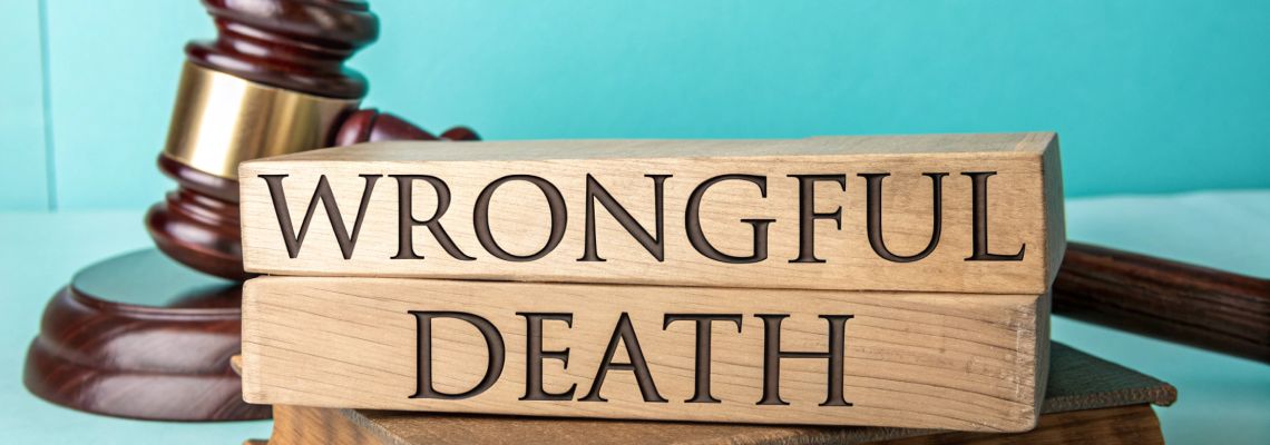 Wrongful Death word on wooden block with gavel in table