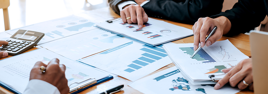People gathered around a table looking at charts