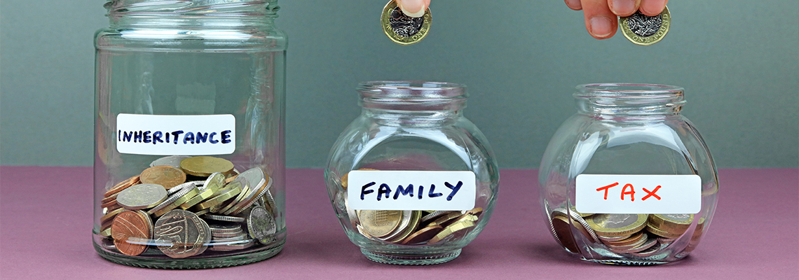 Hands putting coins into different money jars.