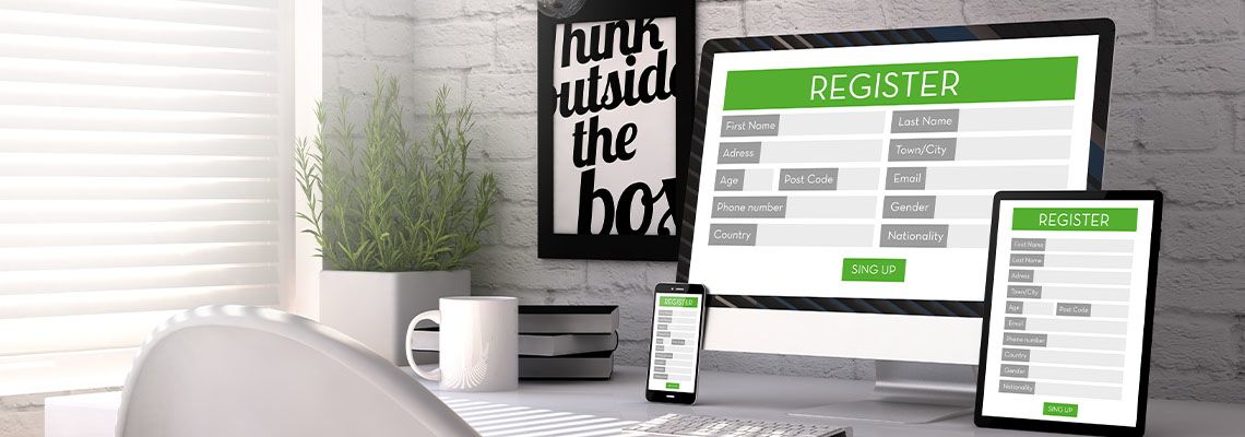 Computer, tablet, and smart phone with registration forms on each screen
