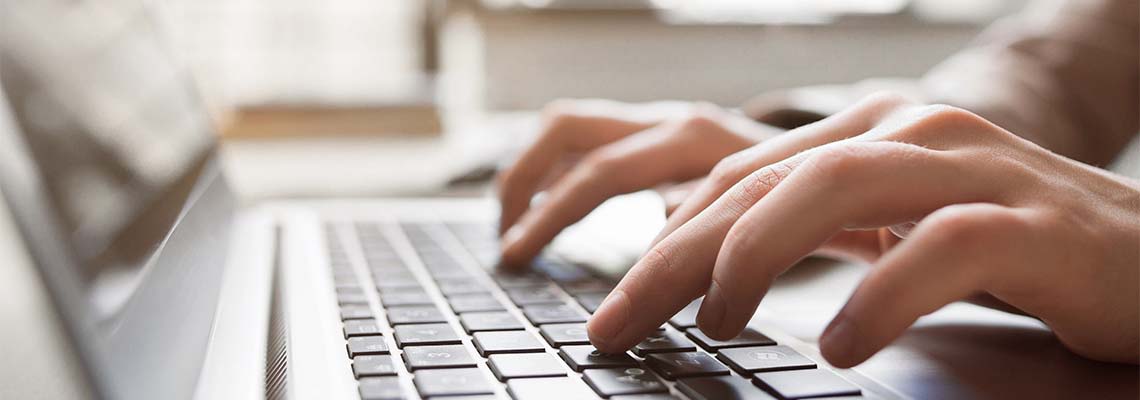 Closeup of typing on laptop