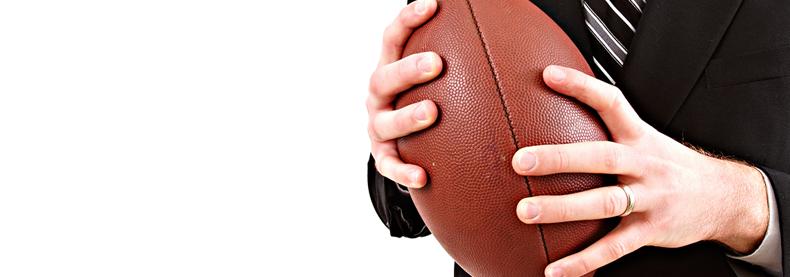 Businessman holding football