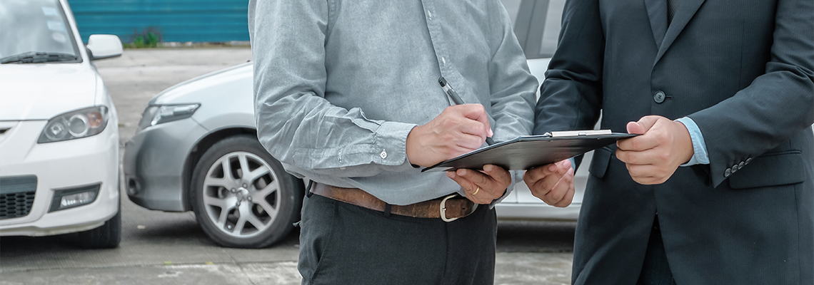 Loss Adjuster Insurance Agent Inspecting Damaged Car.