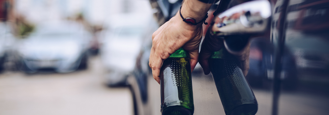 Drunk Driver Drinking Alcohol in Car and Holding Beer