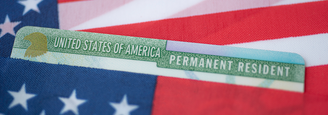 Permanent Resident Green card of United states covered in flag of USA