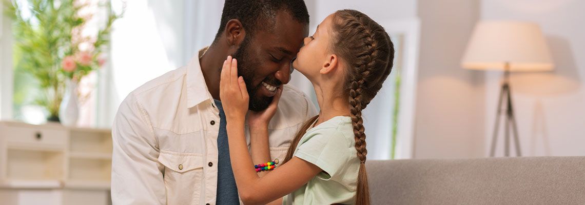 Little girl kissing her stepfather