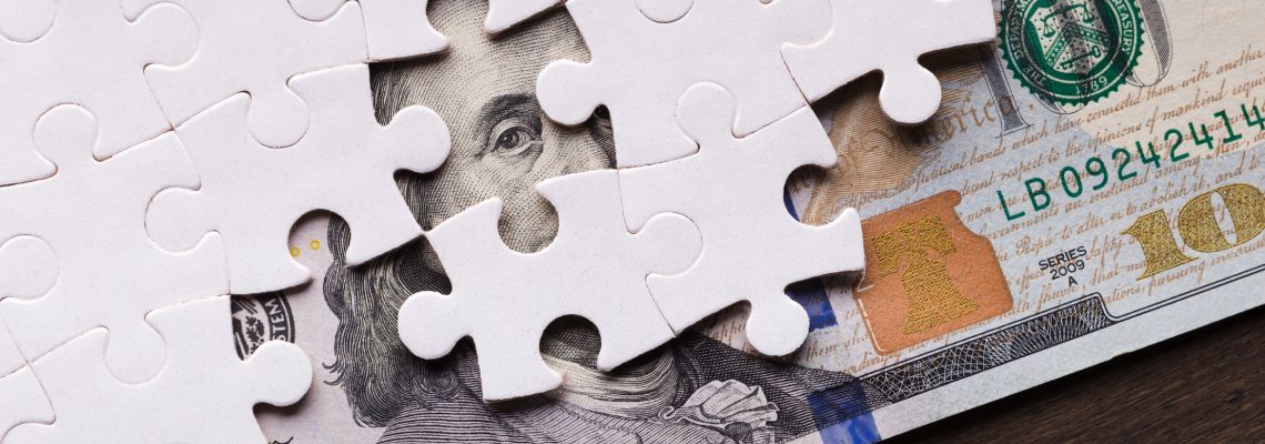 American dollar hidden under puzzle pieces