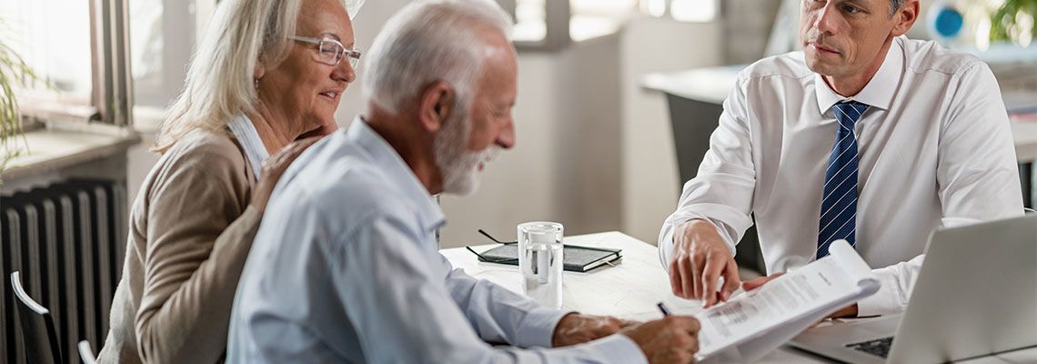 Elderly Couple Signing Estate Planning Documents