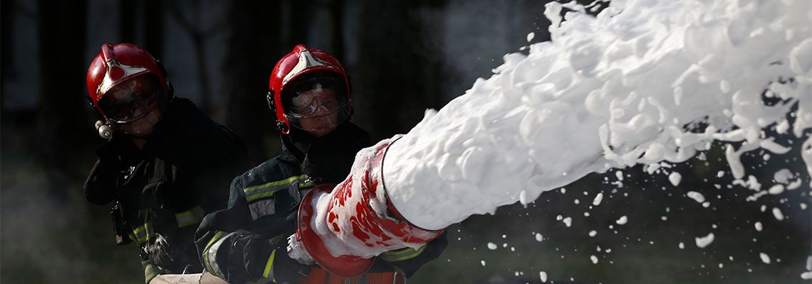 Fire Fighters using foam to extinguish fire