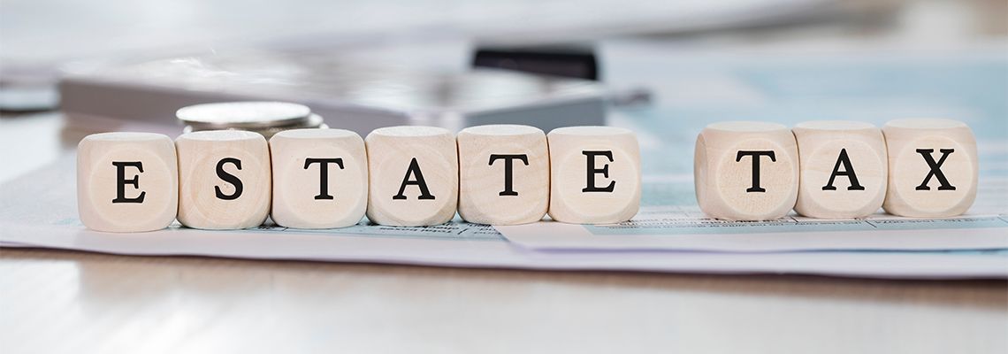 Word ESTATE TAX composed of wooden dices