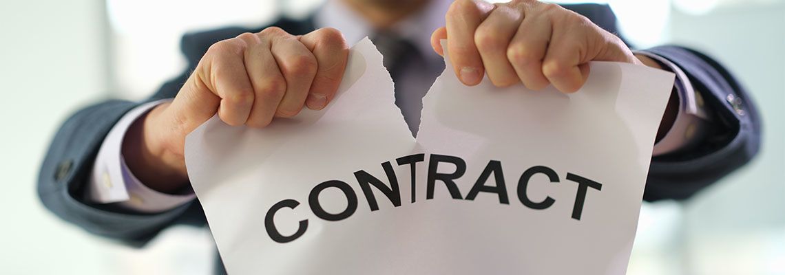 Businessman in suit tearing paper with term contract